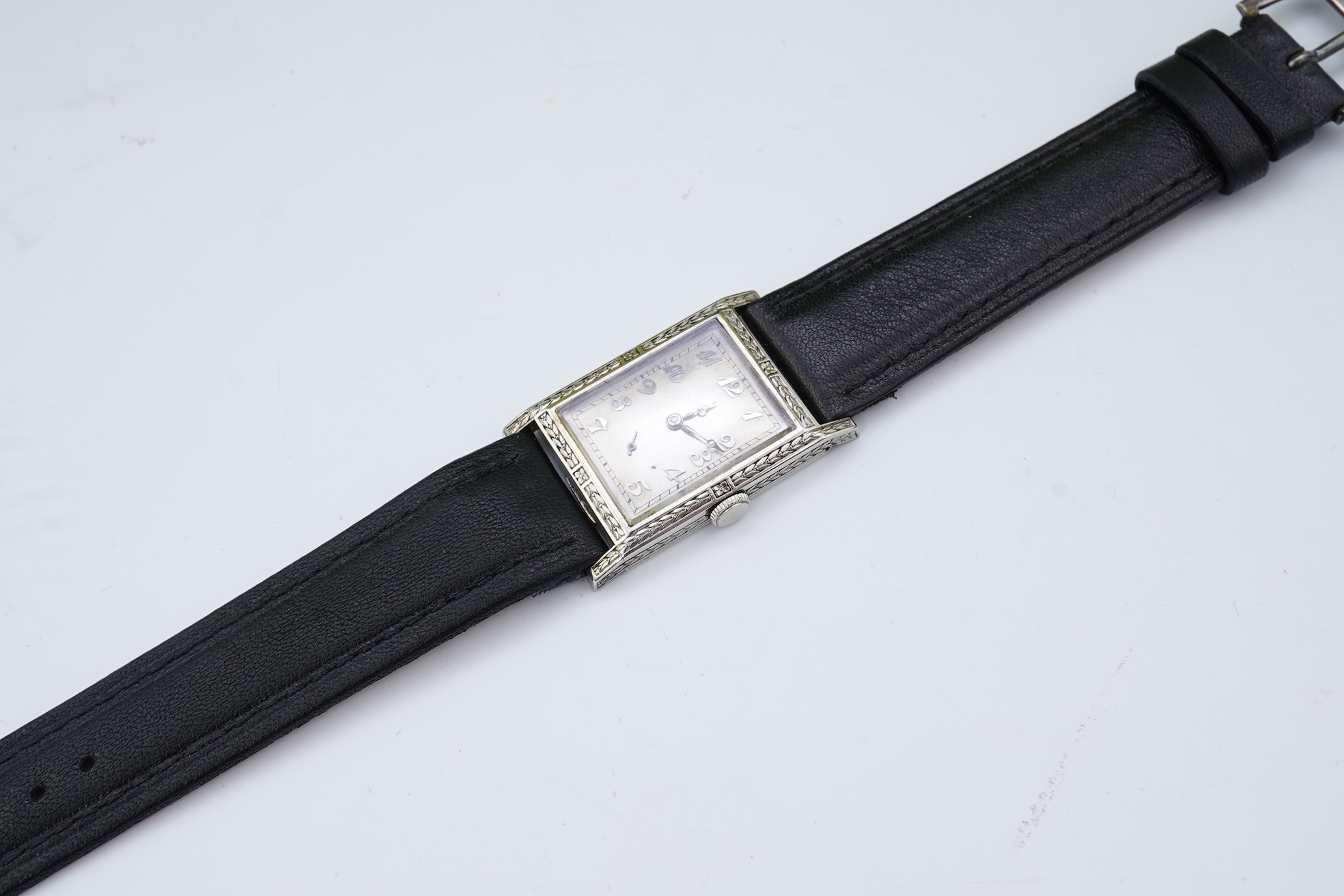 A lady's 18k white gold International Watch Company manual wind wrist watch, on a later associated leather strap